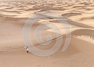 Dubai dessert sand dunes, couple on Dubai desert safari,United Arab Emirates, woman vacation in Dubai