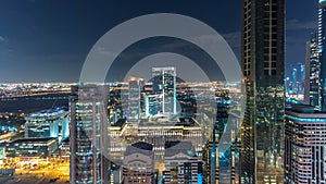 Dubai downtown architecture night timelapse. Top view over Sheikh Zayed road with illuminated skyscrapers and traffic.