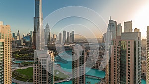 Dubai Downtown cityscape during sunrise with tallest skyscrapers around aerial timelapse