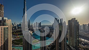 Dubai Downtown cityscape during sunrise with tallest skyscrapers around aerial timelapse