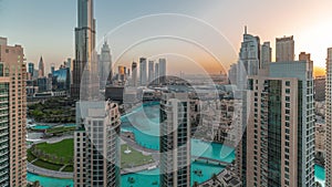 Dubai Downtown cityscape during sunrise with tallest skyscrapers around aerial timelapse