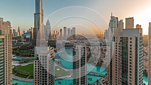 Dubai Downtown cityscape during sunrise with tallest skyscrapers around aerial timelapse