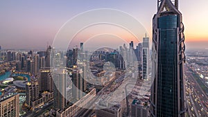 Dubai Downtown day to night timelapse modern towers panoramic view from the top in Dubai, United Arab Emirates.