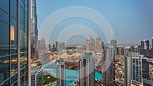 Dubai downtown with fountains and modern futuristic architecture aerial day to night