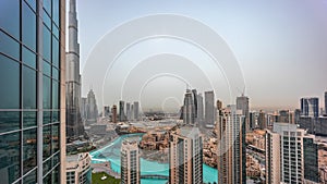 Dubai downtown with fountains and modern futuristic architecture aerial day to night timelapse