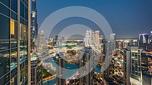 Dubai downtown with fountains and modern futuristic architecture aerial day to night timelapse