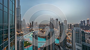 Dubai downtown with fountains and modern futuristic architecture aerial night to day