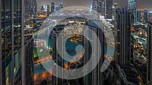 Dubai downtown with fountains and modern futuristic architecture aerial night to day timelapse