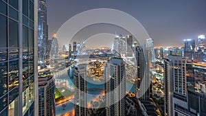 Dubai downtown with fountains and modern futuristic architecture aerial night to day timelapse