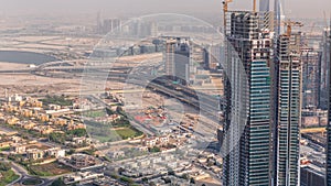 Dubai downtown with large-scale construction of a residential complex with a view of construction cranes aerial