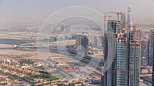 Dubai downtown with large-scale construction of a residential complex with a view of construction cranes aerial