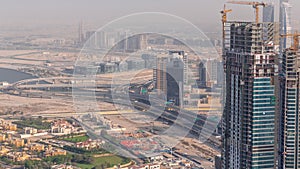 Dubai downtown with large-scale construction of a residential complex with a view of construction cranes aerial