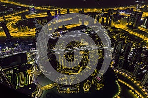 Dubai downtown night scene with city lights. Top view