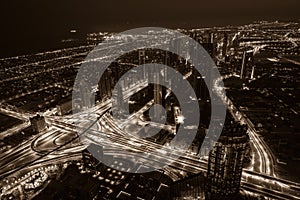 Dubai downtown night scene with city lights. Top view