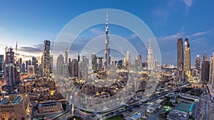 Dubai Downtown skyline day to night timelapse with Burj Khalifa and other towers paniramic view from the top in Dubai