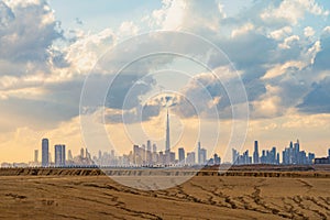 Dubai Downtown skyline with desert sand, United Arab Emirates or UAE. Financial district and business area in smart urban city.