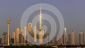 Dubai Downtown skyline landscape with the skyscrapers reflecting golden sun during sunrise.