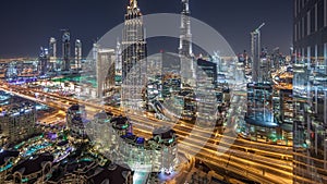 Dubai downtown skyline night timelapse with tallest building and road traffic, UAE