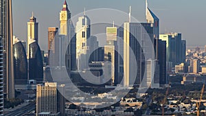 Dubai downtown skyline timelapse at sunset time. Rooftop view of Sheikh Zayed road with numerous towers.