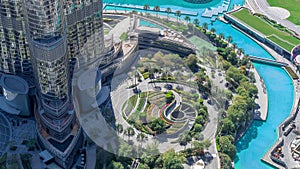 Dubai downtown timelapse with fountain and traffic on circle near entrance to tallest skyscraper