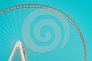 Dubai Eye - the largest Ferris wheel in the world on artificial Bluewaters Island in Dubai, aqua background.