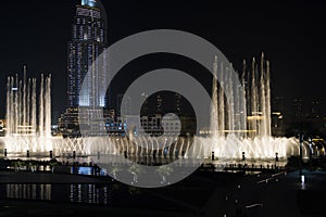Dubai fountains show at night. Tourist attraction dancing fountain at Dubai Mall., UAE