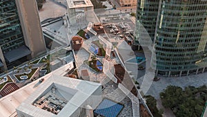 Dubai international financial center skyscrapers with promenade on a gate avenue aerial all day timelapse.