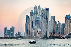 Dubai jumeirah beach with marina skyscrapers in UAE at sunset