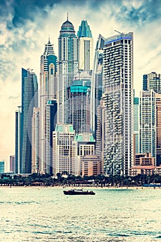 Dubai jumeirah beach with marina skyscrapers in UAE at sunset.