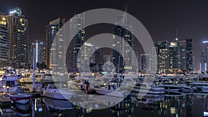 Dubai marina bay with yachts an boats night