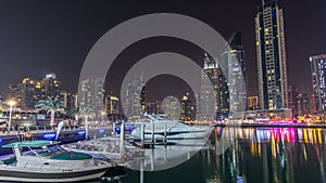 Dubai marina bay with yachts an boats night timelapse hyperlapse