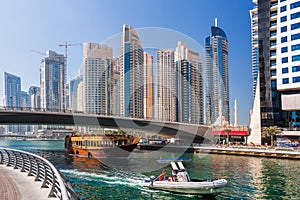 Dubai Marina with boats against skyscrapers in Dubai, United Arab Emirates