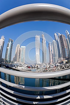 Dubai Marina with boats against skyscrapers in Dubai, United Arab Emirates