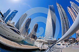 Dubai Marina with boats against skyscrapers in Dubai, United Arab Emirates