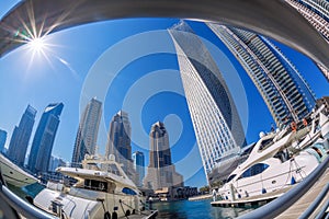 Dubai Marina with boats against skyscrapers in Dubai, United Arab Emirates