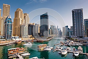 Dubai marina with boats and buildings with gates