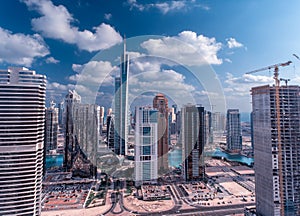 Dubai Marina from drone. Amazing city center skyline with luxury skyscrapers on a sunny day, United Arab Emirates