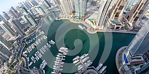 Dubai Marina and Harbour luxury wealth travel with boats yacht in United Arab Emirates from above panorama