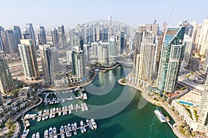 Dubai Marina and Harbour skyline architecture overview wealth luxury travel in United Arab Emirates with boats yacht