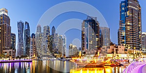 Dubai Marina skyline architecture buildings travel at night twilight in United Arab Emirates panorama