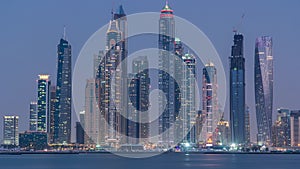 Dubai Marina skyline day to night timelapse as seen from Palm Jumeirah in Dubai, UAE.