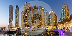 Dubai Marina skyline yacht harbor architecture travel at night twilight panorama in United Arab Emirates