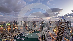 Dubai Marina skyscrapers and jumeirah lake towers view from the top aerial day to night timelapse in the United Arab
