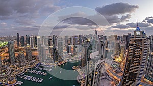 Dubai Marina skyscrapers and jumeirah lake towers view from the top aerial day to night timelapse in the United Arab