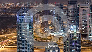 Dubai Marina skyscrapers and jumeirah lake towers view from the top aerial night timelapse in the United Arab Emirates.