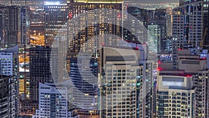 Dubai Marina skyscrapers and jumeirah lake towers view from the top aerial night timelapse in the United Arab Emirates.