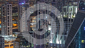 Dubai Marina skyscrapers and jumeirah lake towers view from the top aerial night timelapse in the United Arab Emirates.