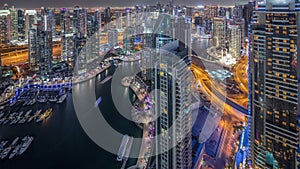 Dubai Marina skyscrapers and jumeirah lake towers view from the top aerial night timelapse in the United Arab Emirates.