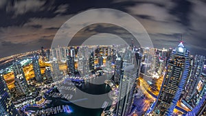 Dubai Marina skyscrapers and jumeirah lake towers view from the top aerial night timelapse in the United Arab Emirates.