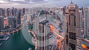 Dubai Marina skyscrapers and jumeirah lake towers view from the top aerial night to day timelapse in the United Arab